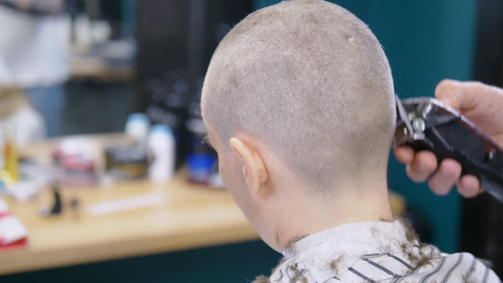 Dad shaves daughter’s head as punishment for bullying cancer-stricken classmate, has “no regrets”